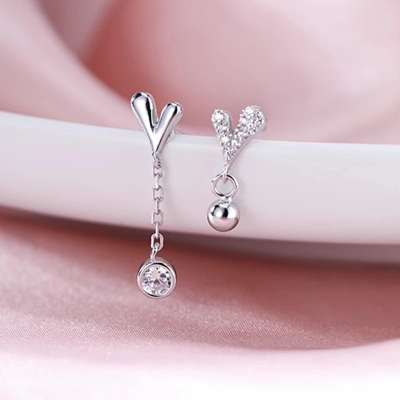 Close-up detail of the sparkling zircons and plating on the Asymmetrical Heart Earrings