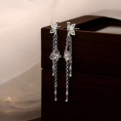 Angled view of the Sterling Silver Bamboo Butterfly Tassel Earrings