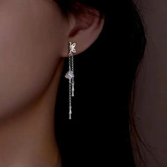 Model showcasing the dangle and style of the Sterling Silver Bamboo Butterfly Tassel Earrings