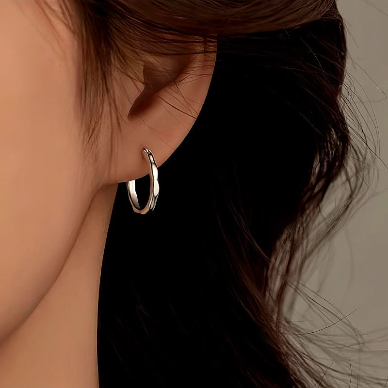 Model showcasing the dangle and style of the Sterling Silver Bamboo Hoop Earrings