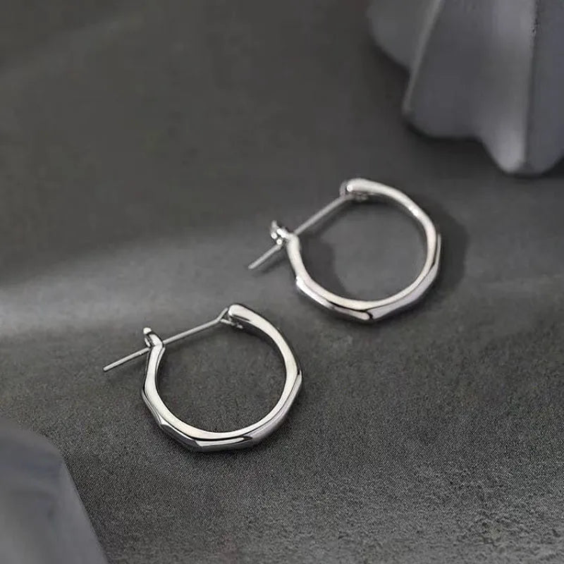 Angled view of the Sterling Silver Bamboo Hoop Earrings