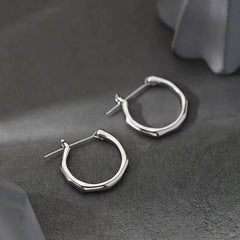 Angled view of the Sterling Silver Bamboo Hoop Earrings