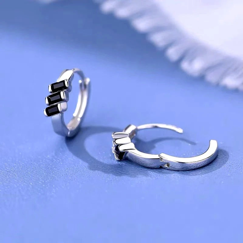 Angled view of the Sterling Silver Black Cube Hoop Earrings