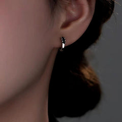 Close-up detail of the sparkling zircons and plating on the Black Cube Hoops
