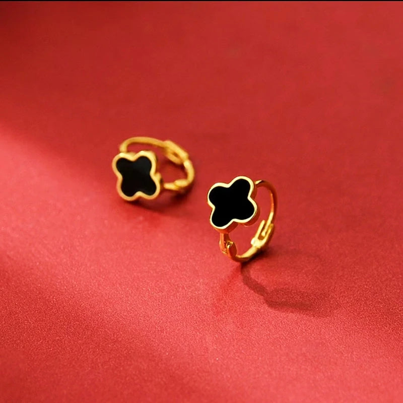 Angled view of the Sterling Silver Black Four-Leaf Clover Hoop Earrings