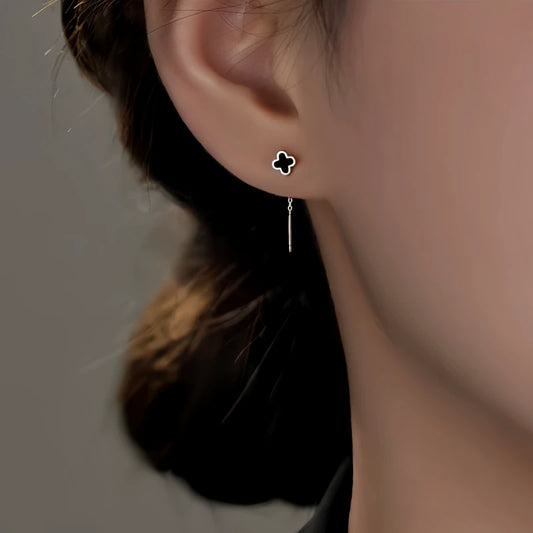 Model showcasing the dangle and style of the Sterling Silver Black Four-Leaf Clover Threader Earrings