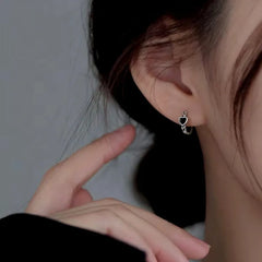 Angled view of the Sterling Silver Black Heart Hoop Earrings