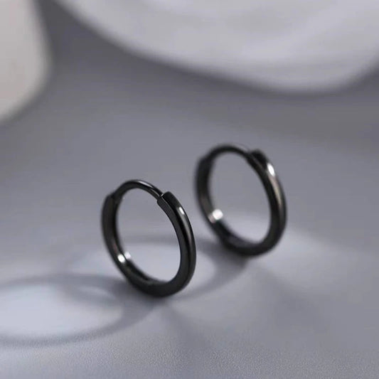 Model showcasing the dangle and style of the Sterling Silver Black Small Hoop Earrings