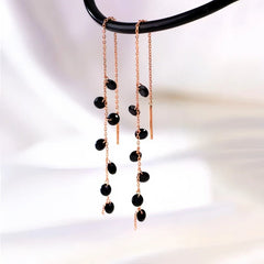 Model showcasing the dangle and style of the Sterling Silver Black Spike Threader Earrings