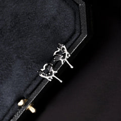 Model showcasing the dangle and style of the Sterling Silver Black Zircon Heart Stud Earrings