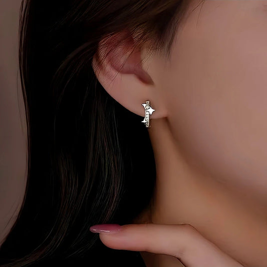 Model showcasing the dangle and style of the Sterling Silver Bling Star Hoop Earrings