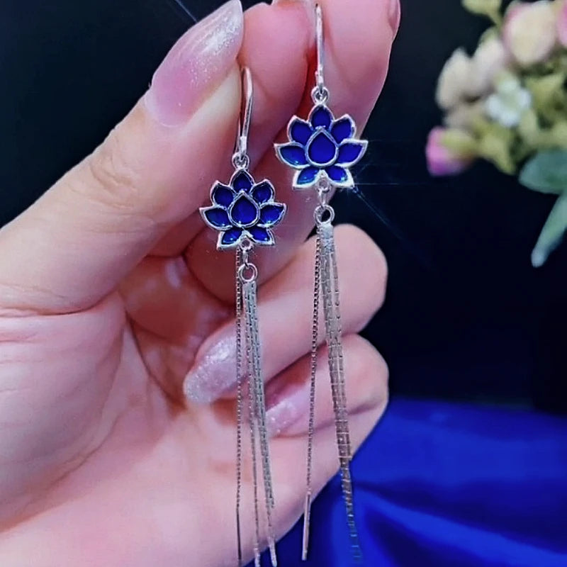 Angled view of the Sterling Silver Blue Lotus Tassel Threader Earrings