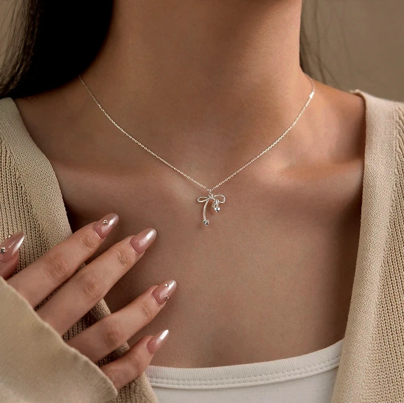 Sterling Silver Bow Necklace worn to showcase its length and pendant detail