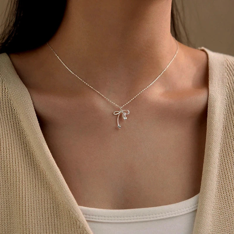 Close-up of the pendant and clasp on the Simple Bow Necklace