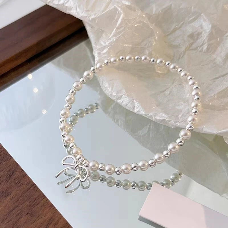 Close-up of the clasp and charm details on the Bow Pearl Bracelet