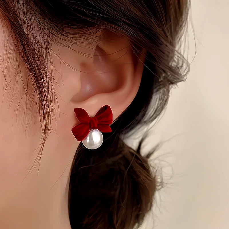 Model showcasing the dangle and style of the Sterling Silver Bow Pearl Earrings