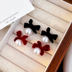 Close-up detail of the sparkling zircons and plating on the Bow Pearl Earrings