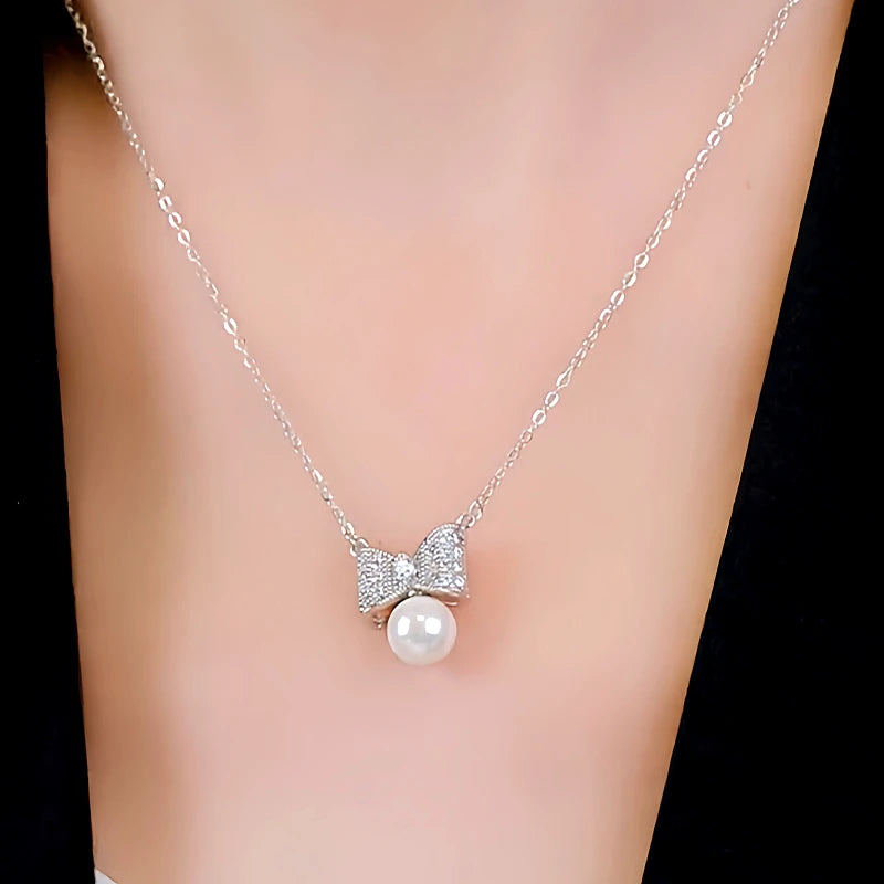 Close-up of the pendant and clasp on the Bow Pearl Necklace