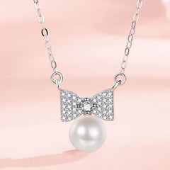 Detailed view of the Sterling Silver Bow Pearl Necklaces chain and pendant