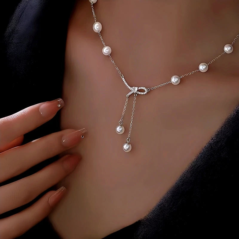 Sterling Silver Bow Pearl Tassel Necklace worn to showcase its length and pendant detail