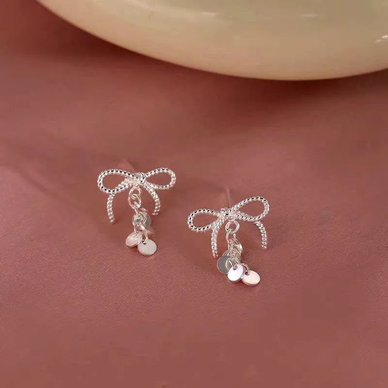 Close-up detail of the sparkling zircons and plating on the Bow Tassel Earrings