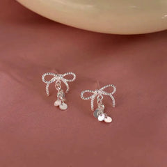 Close-up detail of the sparkling zircons and plating on the Bow Tassel Earrings