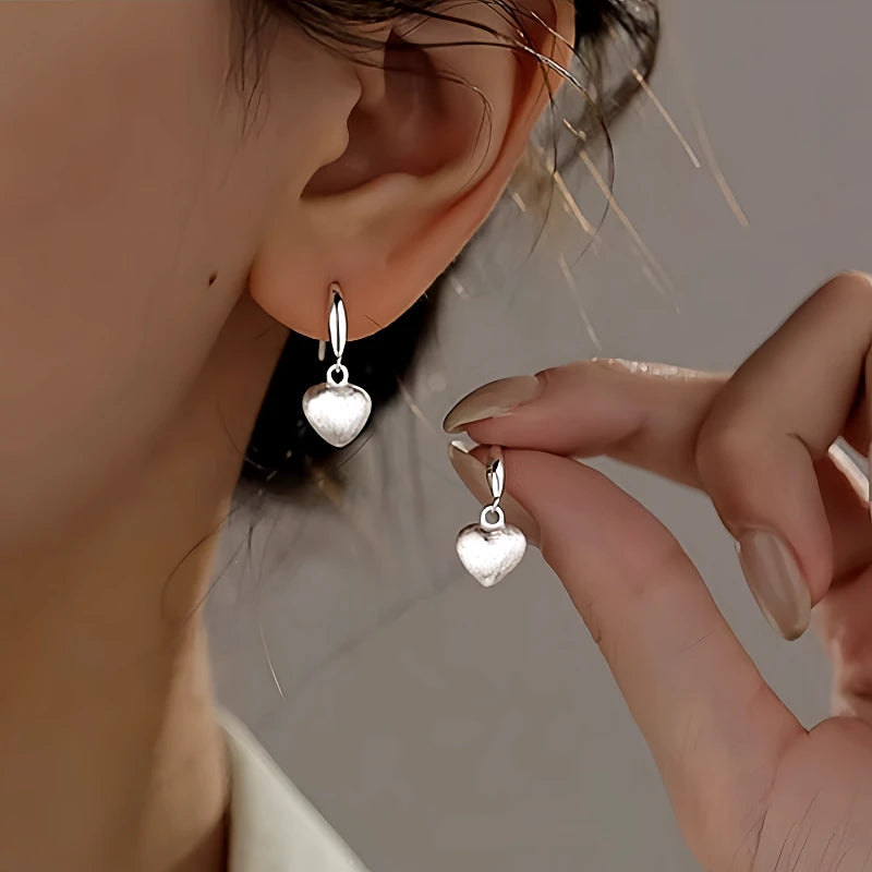 Angled view of the Sterling Silver Brushed Frosted Heart Earrings