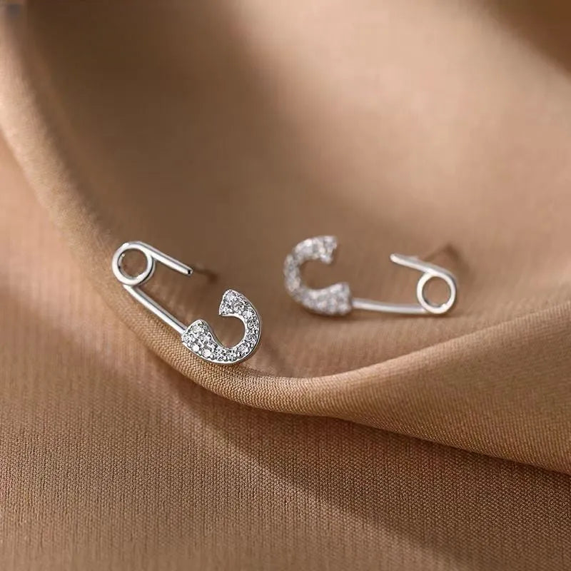 Close-up detail of the sparkling zircons and plating on the Buckle Stud Earrings