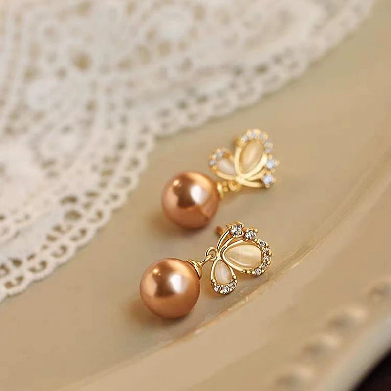 Angled view of the Sterling Silver Butterfly Pearl Earrings