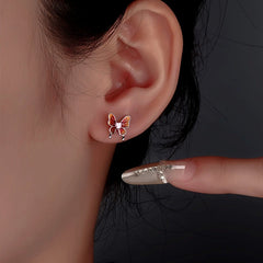 Model showcasing the dangle and style of the Sterling Silver Butterfly Stud Earrings