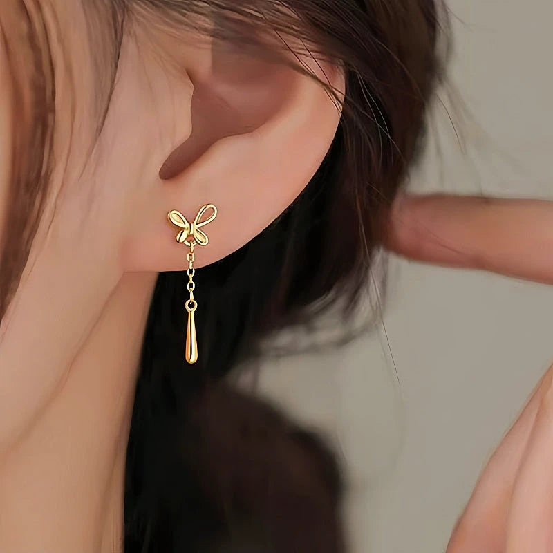 Model showcasing the dangle and style of the Sterling Silver Butterfly Water Drop Tassel Earrings