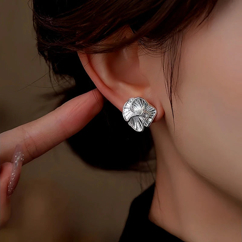 Close-up detail of the sparkling zircons and plating on the Camellia Stud Earrings