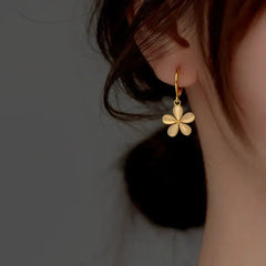 Model showcasing the dangle and style of the Sterling Silver Cat's Eye Stone Flower Earrings