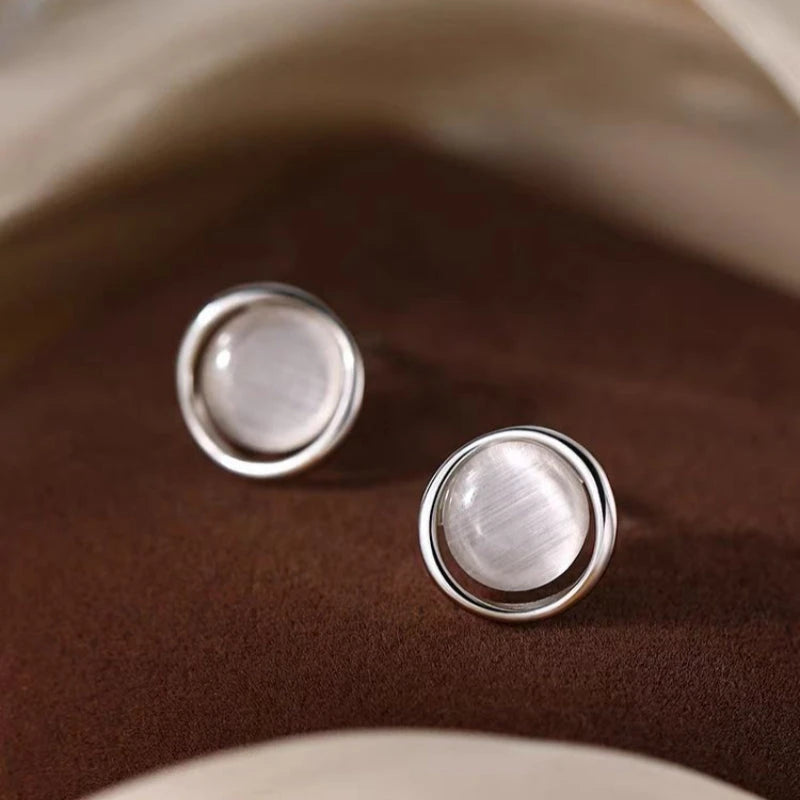 Model showcasing the dangle and style of the Sterling Silver Cat's Eye Stud Earrings