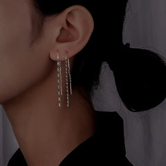 Model showcasing the dangle and style of the Sterling Silver Chain Thrreader Earrings