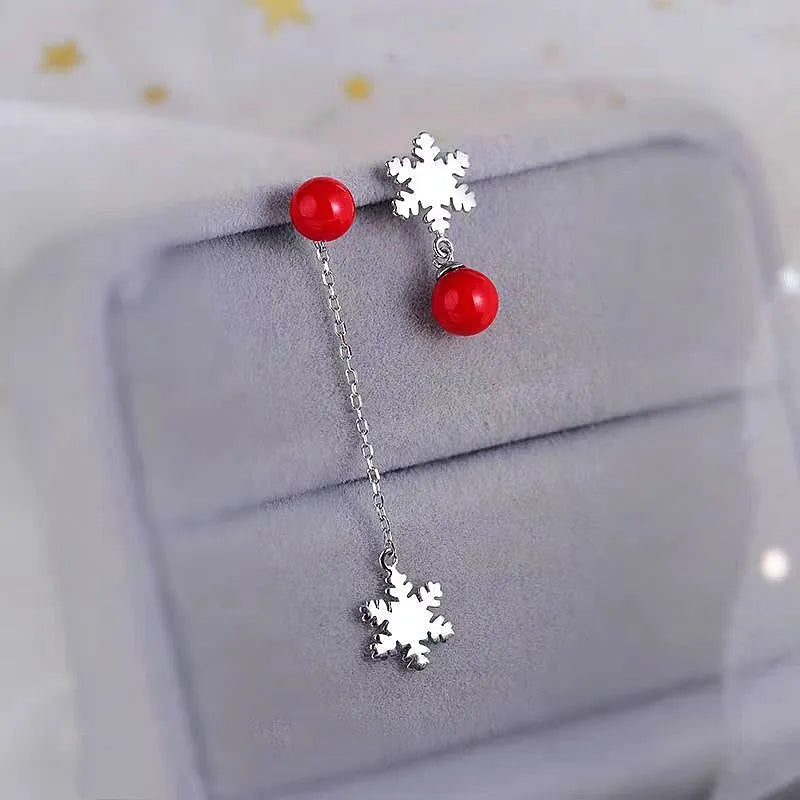 Angled view of the Sterling Silver Christmas Pearl Snowflake Asymmetrical Earrings