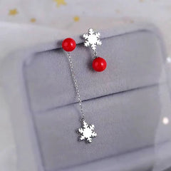 Angled view of the Sterling Silver Christmas Pearl Snowflake Asymmetrical Earrings