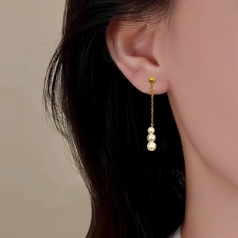 Model showcasing the dangle and style of the Sterling Silver Christmas Pearl Tassel Earrings