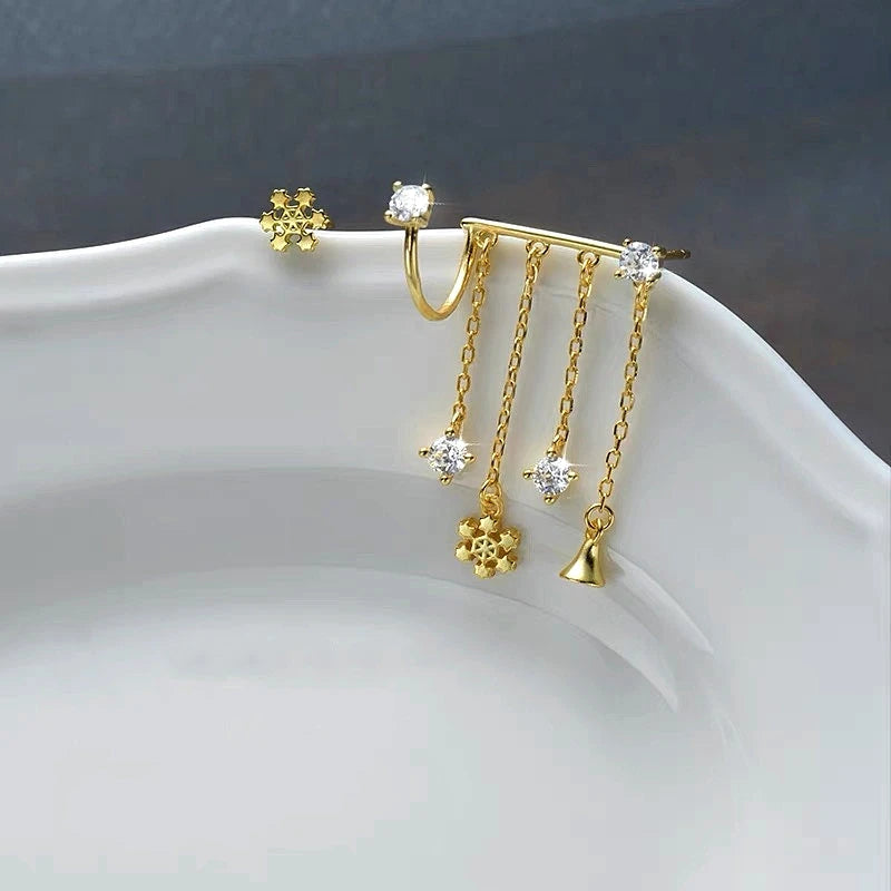 Angled view of the Sterling Silver Christmas Snowflake Bell Tassel Asymmetrical Earrings