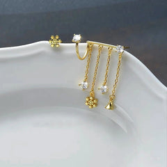 Angled view of the Sterling Silver Christmas Snowflake Bell Tassel Asymmetrical Earrings