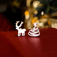 Angled view of the Sterling Silver Christmas Tree And Antler Asymmetrical Stud Earrings