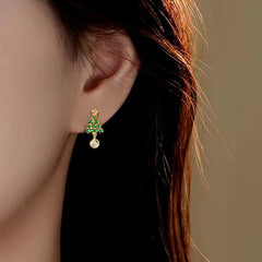 Model showcasing the dangle and style of the Sterling Silver Christmas Tree Earrings