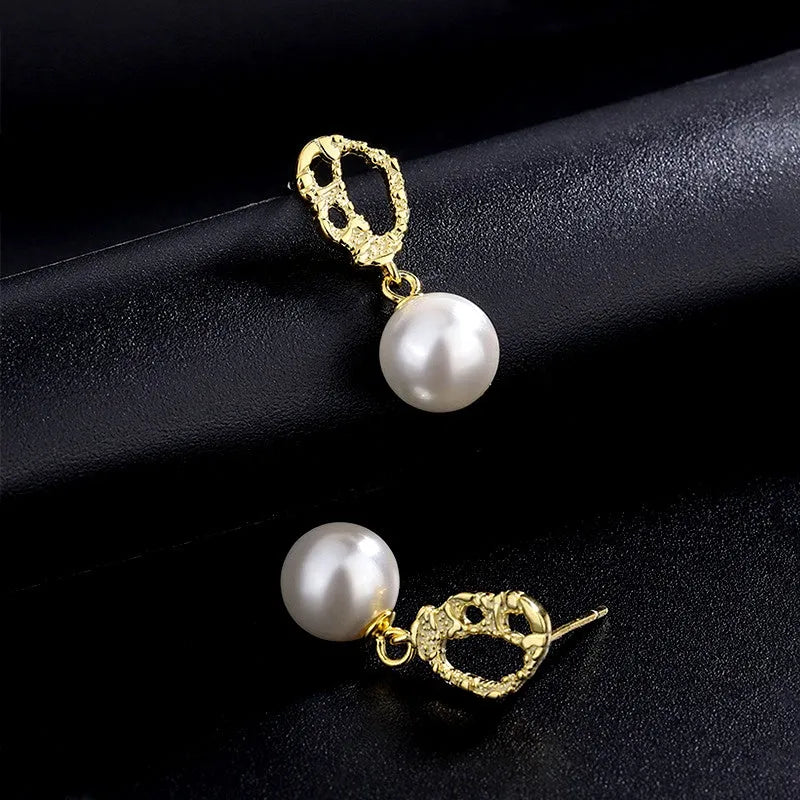 Model showcasing the dangle and style of the Sterling Silver Clown Pattern Pearl Earrings
