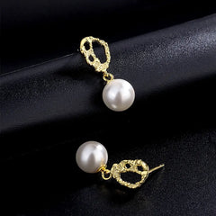 Model showcasing the dangle and style of the Sterling Silver Clown Pattern Pearl Earrings