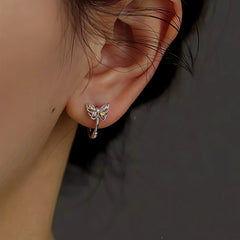 Model showcasing the dangle and style of the Sterling Silver Colorful Diamond Butterfly Hoop Earrings