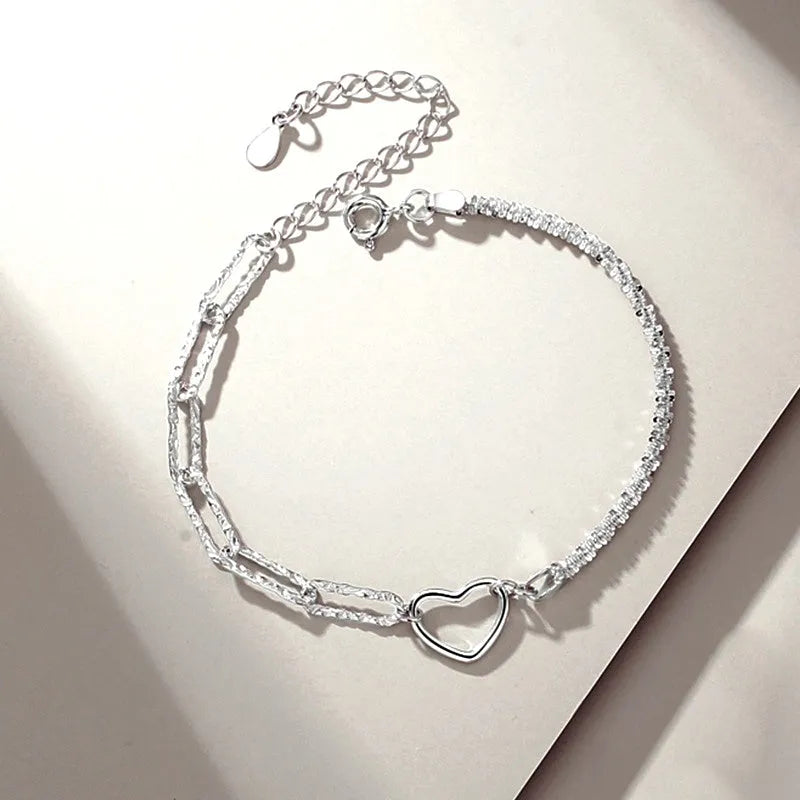 Model wearing the Sterling Silver Couple Star And Heart Bracelets to highlight its design on the wrist