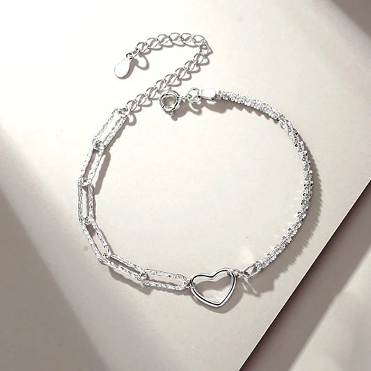 Model wearing the Sterling Silver Couple Star And Heart Bracelets to highlight its design on the wrist