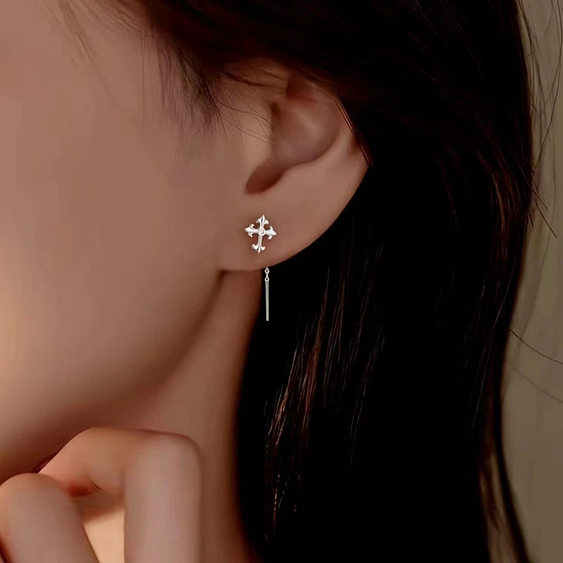 Model showcasing the dangle and style of the Sterling Silver Cross Tassel Threader Earrings