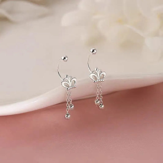 Model showcasing the dangle and style of the Sterling Silver Crown Tassel Screw Earrings