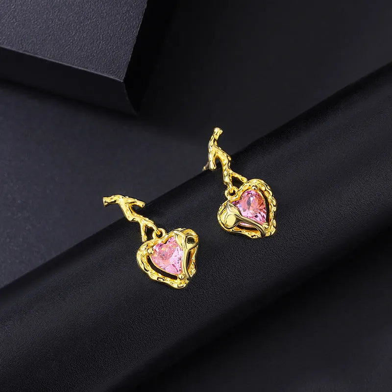 Model showcasing the dangle and style of the Sterling Silver Crystal Pink Heart Earrings